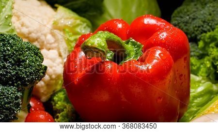 Closeup Photo Of Water Dropelts On Red Bell Pepper On Kitchen Desk. Background For Healthy Food And 