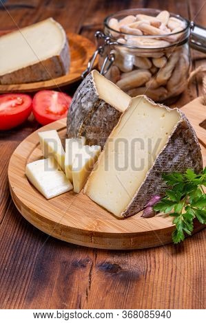 Pieces Of Cheese Tomme De Montagne Or Tomme De Savoie Made From Cow Milk In French Alps.