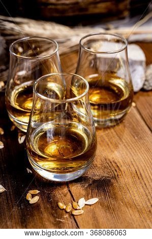 Speyside Scotch Whisky Tasting On Old Dark Wooden Vintage Table With Barley Grains Close Up