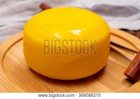 One Small Head Of Dutch Baby Gouda Cheese In Yellow Wax