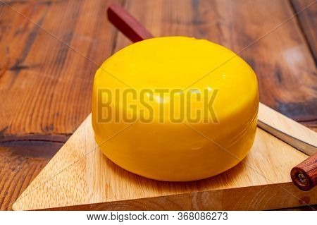 One Small Head Of Dutch Baby Gouda Cheese In Yellow Wax