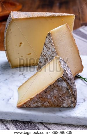 Pieces Of Cheese Tomme De Montagne Or Tomme De Savoie Made From Cow Milk In French Alps.