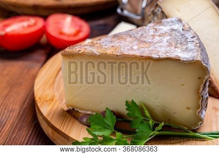 Pieces Of Cheese Tomme De Montagne Or Tomme De Savoie Made From Cow Milk In French Alps.
