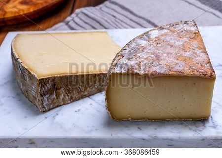 Pieces Of Cheese Tomme De Montagne Or Tomme De Savoie Made From Cow Milk In French Alps.