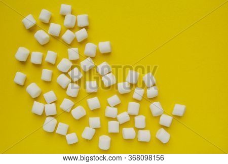 Marshmallows On Yellow Background With Copyspace. Flat Lay Or Top View. Background Or Texture Of Col