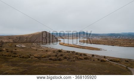 River And Road In The Hilly Terrain Of Siberia. The City Of Ulan-ude. Aerial Shot