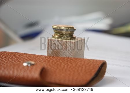 Brown Leather Wallet And Stack Of Bronze Coins Put On Wooden Cube. Little Money Or Powerty Concept. 
