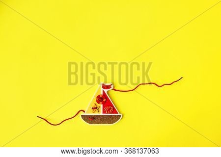 Toy Wooden Boat With Laces On A Yellow Background