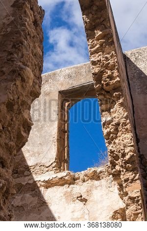 Broken Walls And Roof Of A Ruin Of An Abandoned House. View From Inside Of The Building. Broken Wind