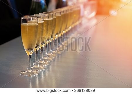 Row Of Glasses With Sparkling Wine, Champagne Or Proseco Close-up. Wine Tasting, Warm Toned Photo