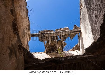 Frame Made Of Broken Walls And Roof Of And Abandoned House. View From Inside Of The Building Up On A