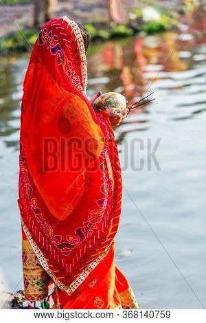 Kathmandu,nepal - November 1,2019: Hindu Devotee Offering Prayers To Sun God Standing In Water Accor