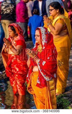 Kathmandu,nepal - November 1,2019: Hindu Devotees Offering Prayers To Sun God Standing In Water Acco