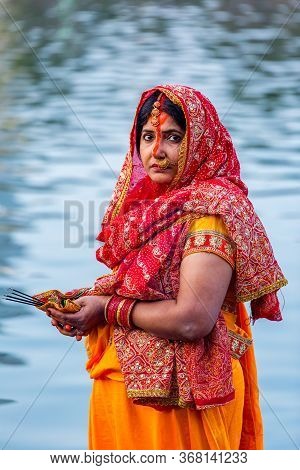 Kathmandu,nepal - November 1,2019: Hindu Devotee Offering Prayers To Sun God Standing In Water Accor