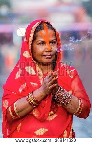 Kathmandu,nepal - November 1,2019: Hindu Devotee Offering Prayers To Sun God Standing In Water Accor