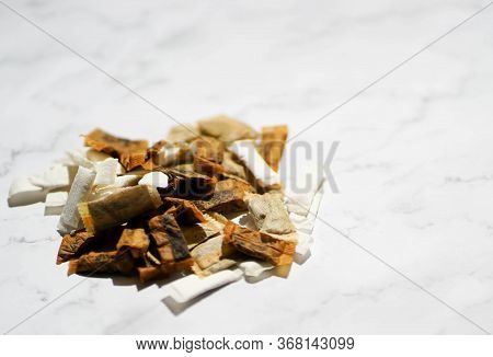 Swedish Snus Chewing Tobacco On A White Granite Background.