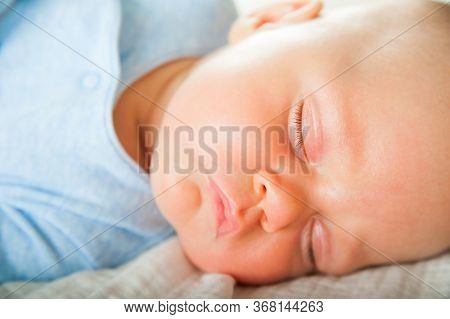 Newborn Sleeping Close Up. Baby Is Sleeping Soundly On The Bed And Copy Space. Infant Care, Colic, S