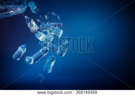 Plastic Bottles Sinking In To The Ocean. Enviromental Polution Concept. World Ocaens Day