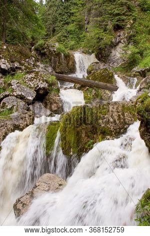 River Forming Waterfalls In Cetatile Ponorului, Apuseni Natural Park, Romania