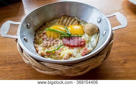 Egg Pan Breakfast At The Hotel On A Wooden Table.