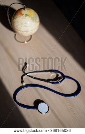 Globe And Stethoscope. The Concept Of Global Warming And Pollution. Phonendoscope And Earth Miniatur
