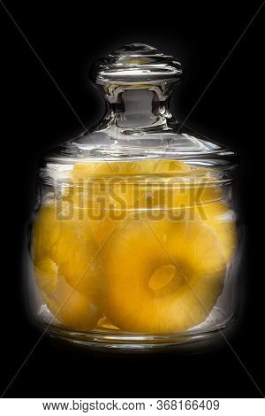 Dried Pineapple Candy Rings, In Powdered Sugar, Close-up Under Sunlight, Lying In A Transparent Glas