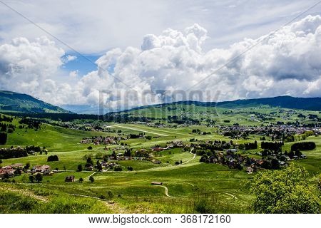 Wonderful View Of The Mountains Around The Asiago Plateau With Green Pastures With Yellow And White 