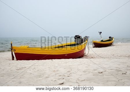 Fishing Boats On The Beach On A Cloudy And Foggy Day. Baltic Sea, Poland