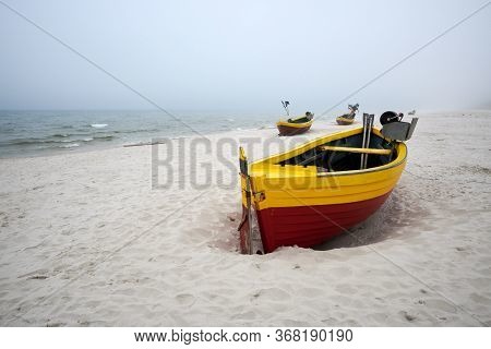 Fishing Boats On The Beach On A Cloudy And Foggy Day. Baltic Sea, Poland