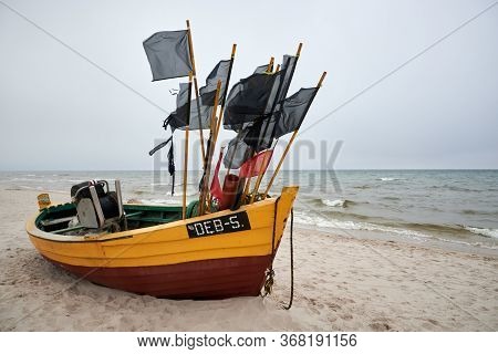 Debki, Poland- May 25, 2020: Fishing Boat On The Beach On A Cloudy And Foggy Day. Baltic Sea, Poland