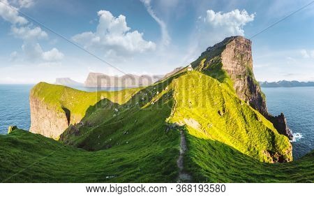 Panorama of green faroese hills and Kallur lighthouse on Kalsoy island, Faroe islands, Denmark. Landscape photography