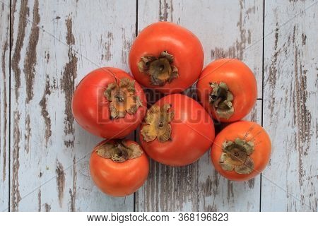 Persimmon Date-plum Tasty And Healthy For Human Health On A Table In The Garden