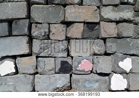 Pile Of Used And Damaged Grey Cinder Blocks. Construction Idea Concept.