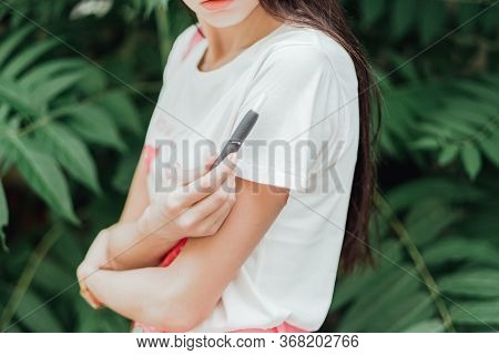 Heating Tobacco System Iqos On Summer Background, Iqos Tobacco Product Technologies.