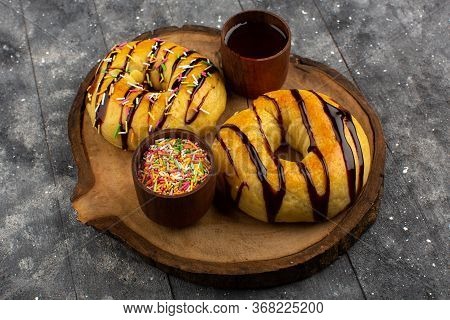 A Top View Donuts Yummy Delicious On The Brown Desk And Grey Background