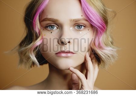 Closeup Portrait Of Beautiful Young Woman With Golden Glitter Stars On Her Face.