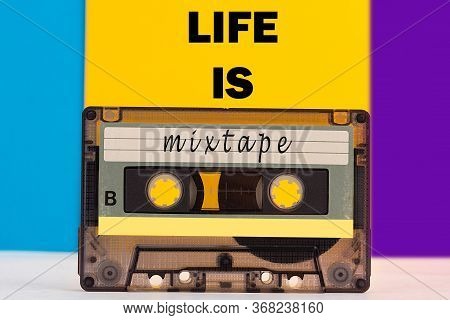 Top View Of Audio Cassette With Life Is A Mixtape Inscription On Colorful Background