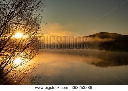 A Dramatic Sunrise With Low Cloud And Mist Over The Small Lake In Twizel New Zealand