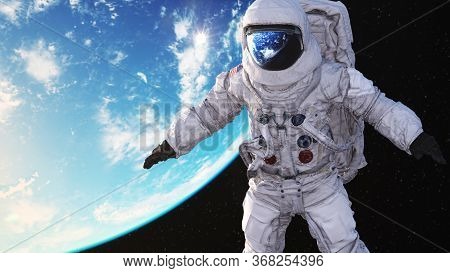 Astronaut In Orbit In Space Around Planet Earth