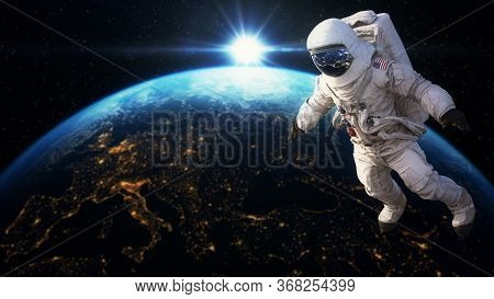 Astronaut Flying  In Space Above Planet Earth