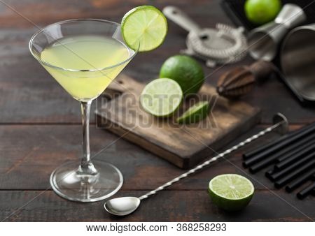 Gimlet Kamikaze Cocktail In Martini Glass With Lime Slice And Ice On Wooden Background With Fresh Li