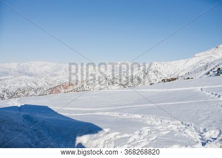 Tien Shan Mountains Covered With Snow In Uzbekistan On A Clear Day. Beldersay Ski Resort