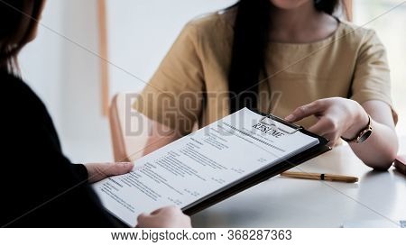 Interviewer Reading A Resume, Person Submits Job Application, Person Describe Yourself To Interviewe
