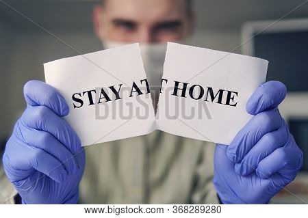 End Of Covid-19 Pandemic. Man Tearing Card With Hashtag Stay At Home. Victory In Fight Against Pande