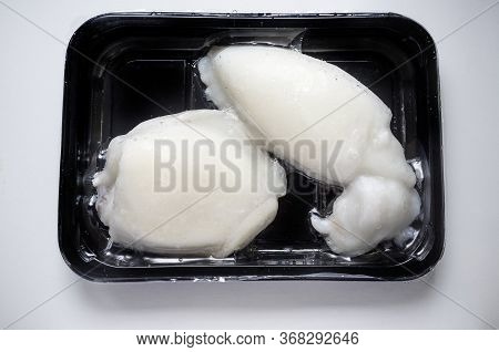 Tray Of Whole Frozen Cuttlefish. Overhead Shot