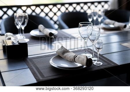 Served Wooden Table With Three Empty Wineglasses