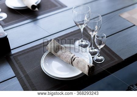 Served Wooden Table With Three Empty Wineglasses