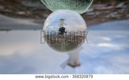White Windmill At End Of Coast Full Of Puddles Near Baltic Sea In Swinoujscie In Reflection Of Cryst