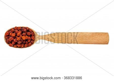 Dried Sorbus In A Wooden Spoon On A White Background. Phytotherapy And Disease Prevention. Herbal Co