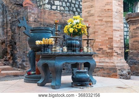 Buddhist Altar With Candles And Bananas And Flowers In The Temple On Table